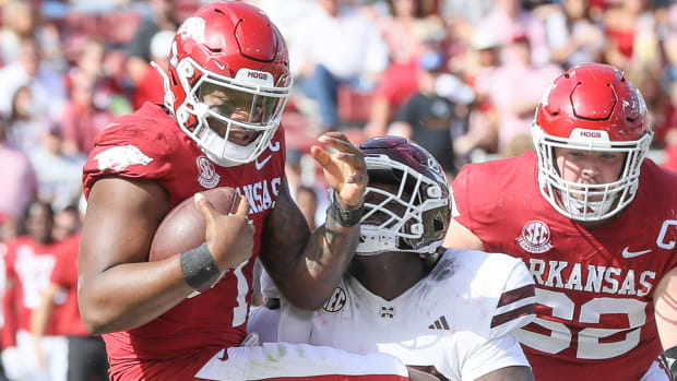 Razorbacks quarterback KJ Jefferson gets nailed by Mississippi State's Nathan Pickering